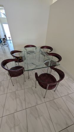 Glass dining room table with vintage chairs.