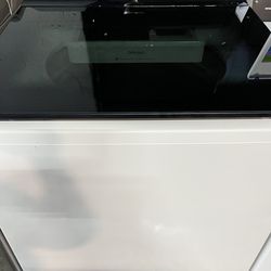 The LG WT8405CW is a 5.3 cu. ft. mega-capacity top-load washer with an agitator, measuring approximately 27" W x 43" H x 28.38"