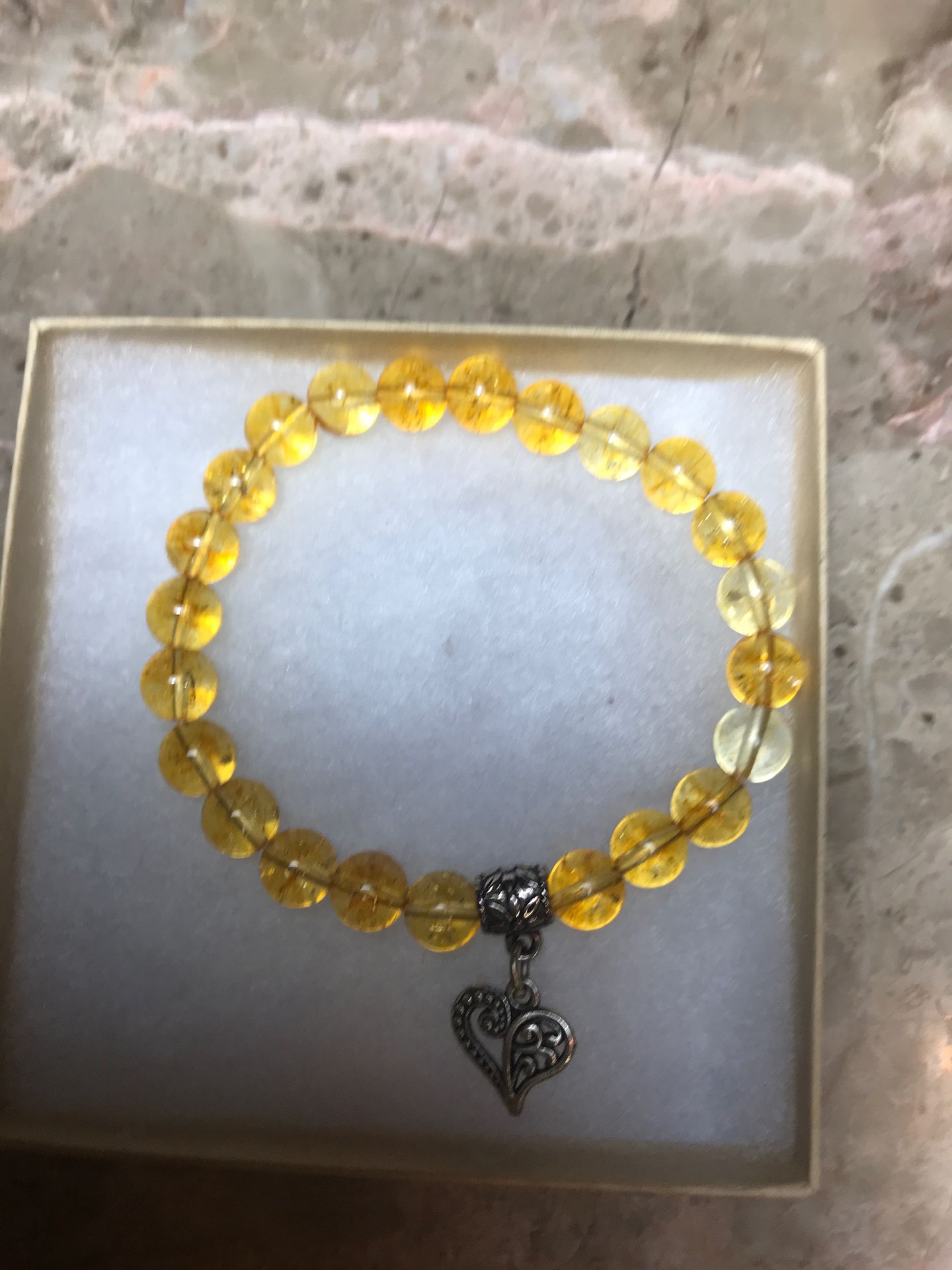 Citrine semiprecious gemstone stretch bracelet with heart charm. 8 inches