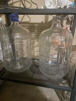 3 gallon glass water bottles with 2 metal stands and 2 toppers for water disbursement