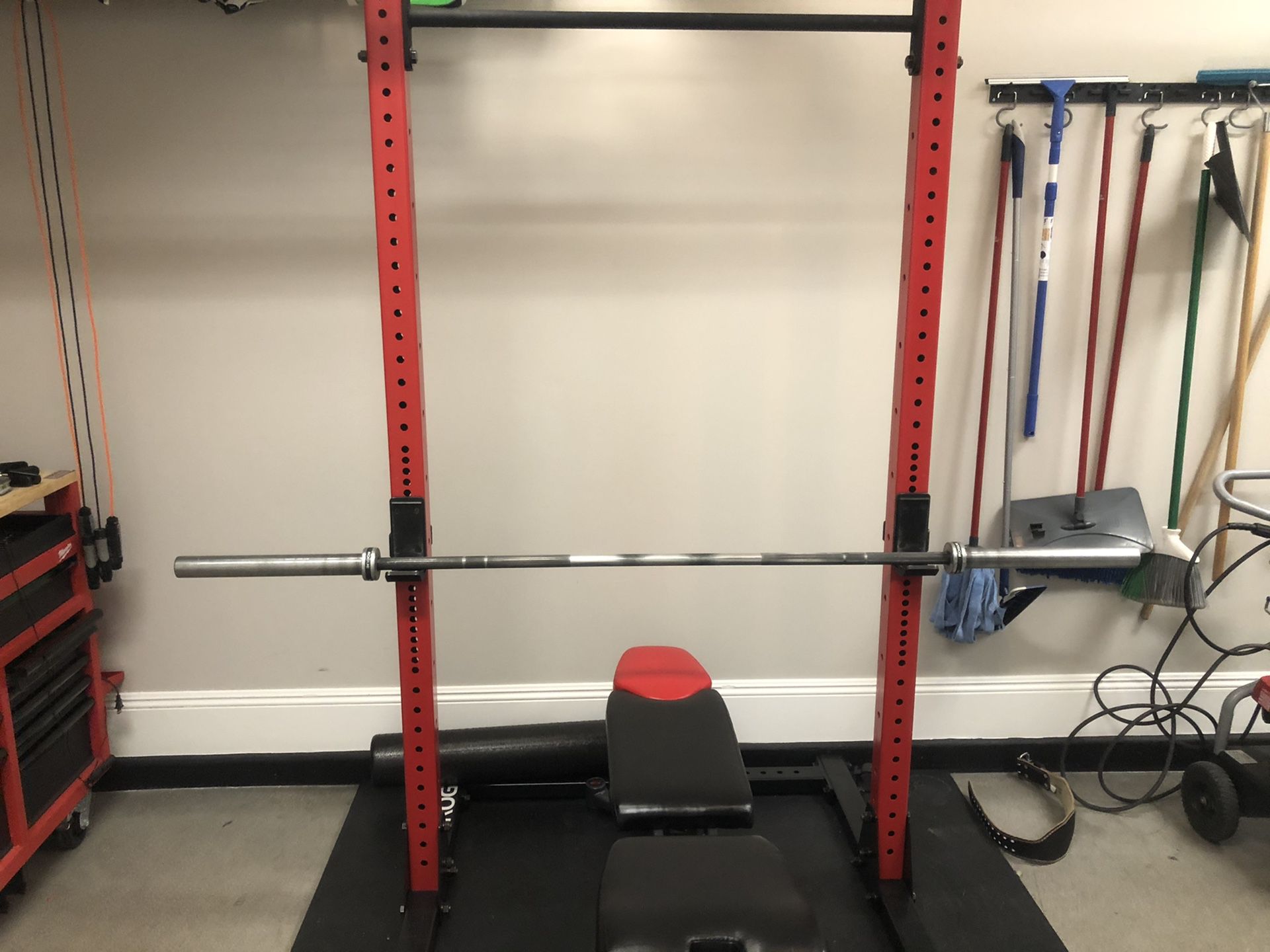 Rogue squat rack with bench, barbell and weights