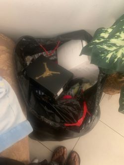 Bag of baby clothes and shoes