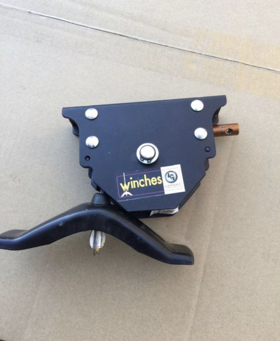 Lippert spare tire winch with offset cable