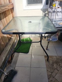 Outside glass table with umbrella
