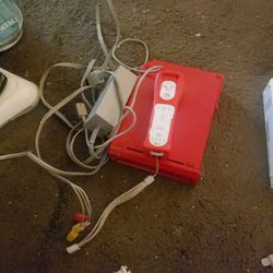 2 Nintendo wiis, a steering wheel, a wii fit Board and a Wireless sensor bar 