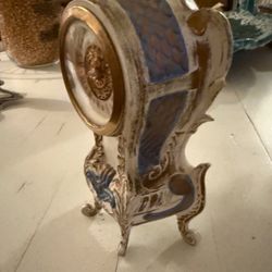 This is a Dresden-style porcelain mantel clock.