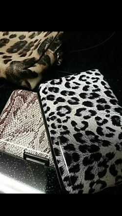 TWO HARD CASE WALLETS IN ANIMAL PRINTS