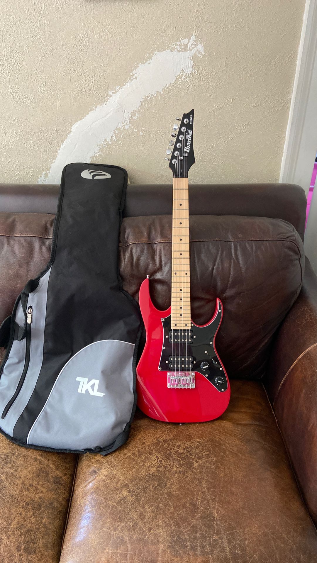 Red and black electric guitar with gig bag( Ibanez) mikro size