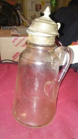 Glass and medal I believe old oil canister