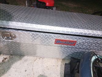 This is a Duralast brand aluminum truck tool chest featuring a classic diamond plate finish.
