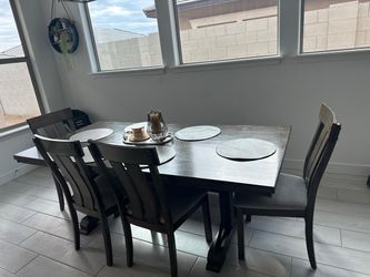 Dining table with chairs and a bench