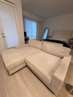 Beige sectional with wood legs