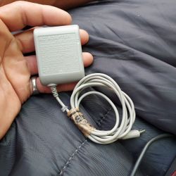 This is a genuine Nintendo DS Lite AC power adapter with model number USG-002