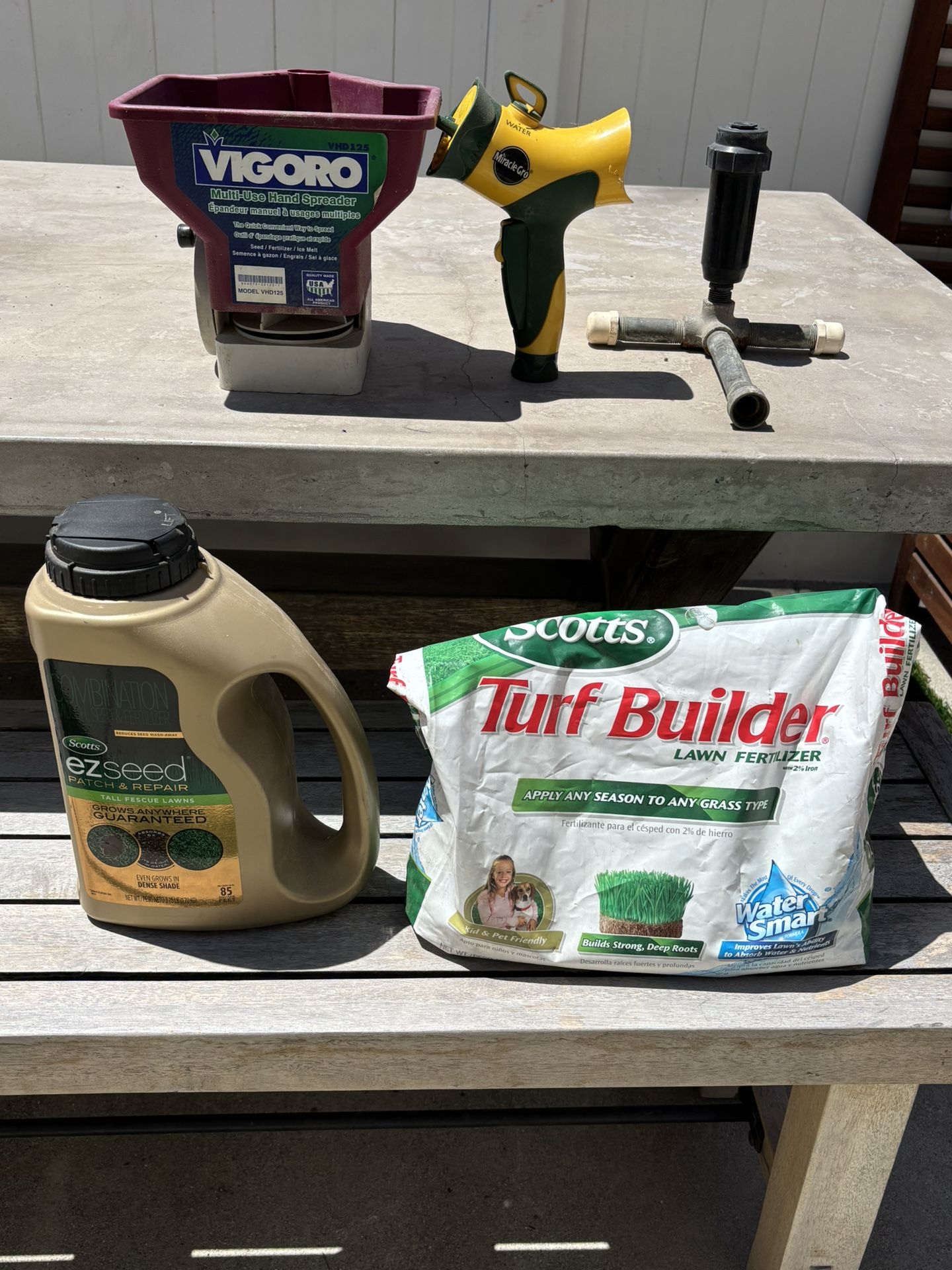 lot of lawncare items - seed tools sprinkler fertilizer spreader nozzle