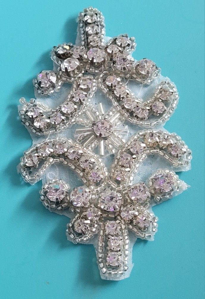 3.5" Crystal Iron On Clear Rhinestone Ornate Pattern Swirling Shapes Applique. The image shows a detailed view of a rhinestone iron-on applique. This