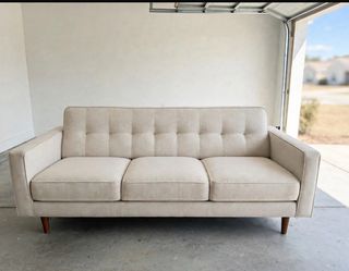 On Fontana Used beige linen 3-seat sofa. Good used condition, clean and comfortable. Kept in clean garage. Wood legs, tufted back detail. No major rip