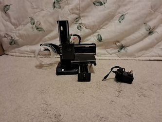 Easy Thread 3d printer with filament and charging cable with adapter.
