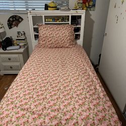 Twin XL bed with storage and bookcase. 