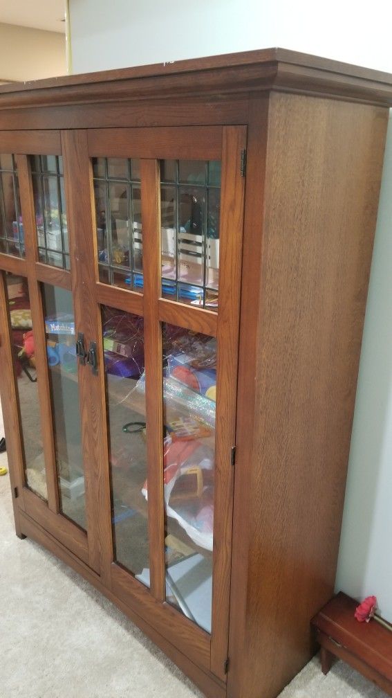 solid wood Almirah with glass doors.