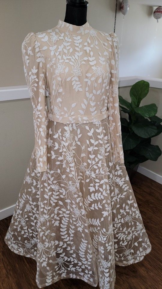 An elegant beige dress designed specifically for veiled women, combining elegance and modesty.