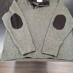 This is a Weatherproof Vintage Men's Fleece Quarter-Zip Sweater with Sherpa in a green color with brown corduroy elbow patches and collar trim. 