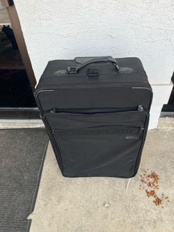 Briggs and Riley medium sized luggage  black checked baggage, wheeled lifetime warranty