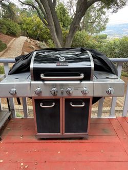 Heavy-duty Fire King 4-burner stainless steel propane gas grill.