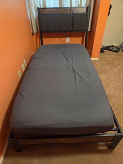 Twin bed with mattress and electric charging headboard