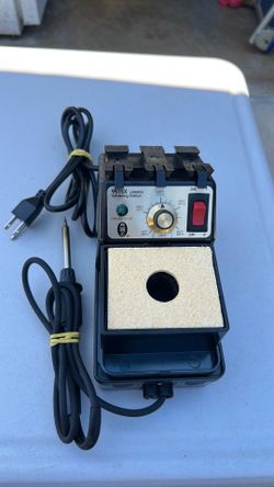 Soldering iron with station