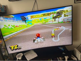 Nintendo Wii console with remote nunchuk and sensor bar and Mario kart game