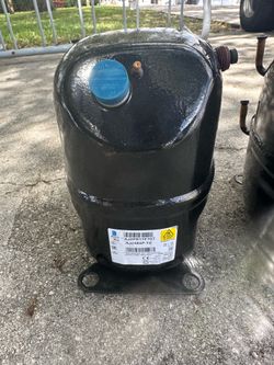 This is a Tecumseh AJ2464P-TZ commercial refrigeration compressor.