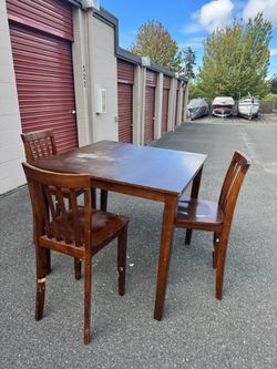 Square wooden high table and 3 chairs