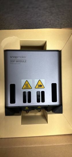 New Snapmaker Dual Extrusion 3D Printing Module has a grey metal housing with dual nozzles. This module is compatible with Snapmaker 2.0 and Artisan s