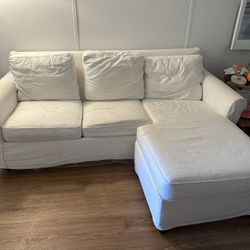 White couch with pull out bed and right trundle