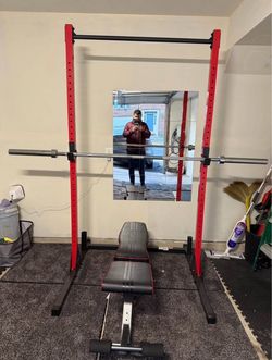 Red Squat Rack with Barbell and Weight Bench