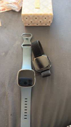Two Fitbit versa four smart watches