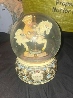 Bainbridge Bears "Carousel of Dreams" musical snow globe featuring a cute teddy bear riding a carousel horse atop a decorated base inscribed with the