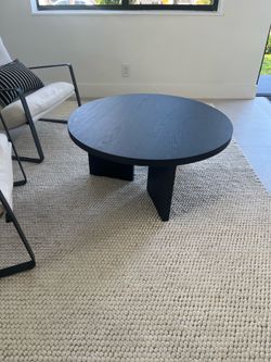 Round black wooden coffee table