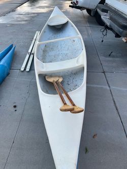 White Fiberglass Canoe with Wooden Paddles