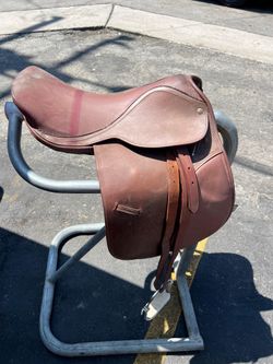 Horse saddle with metal stand