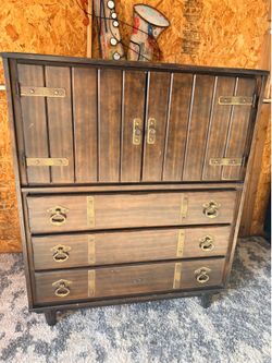 vintage Furniture dresser featuring wood construction with brass hardware accents