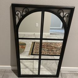 Arched wall/Floor mirror featuring a dark metal frame and decorative metal scrollwork in the upper corner.