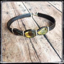** Men’s brown leather bracelet with amber stone.
