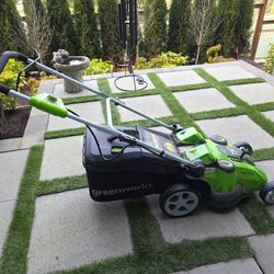 Greenworks lawn mower, leaf blower, charger, and two batteries 
