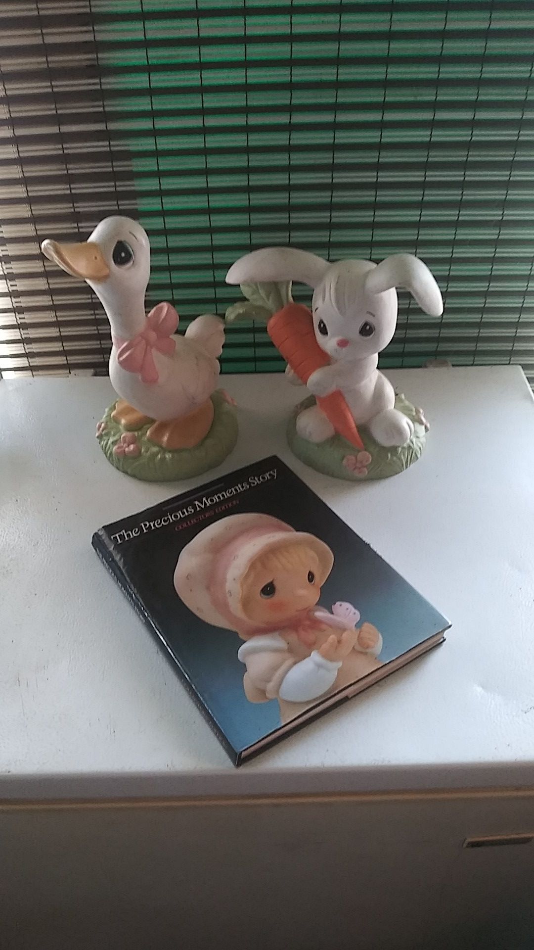 Two Precious Moments figurines and book
