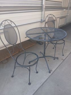 Vintage wrought iron bistro.  table and 2 chairs