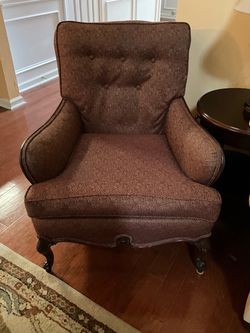 Traditional tufted accent armchair with a reddish-brown textured geometric jacquard fabric and dark carved cabriole legs.