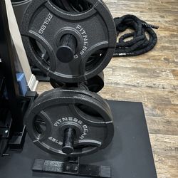 255 lb Olympic weight plates + rack