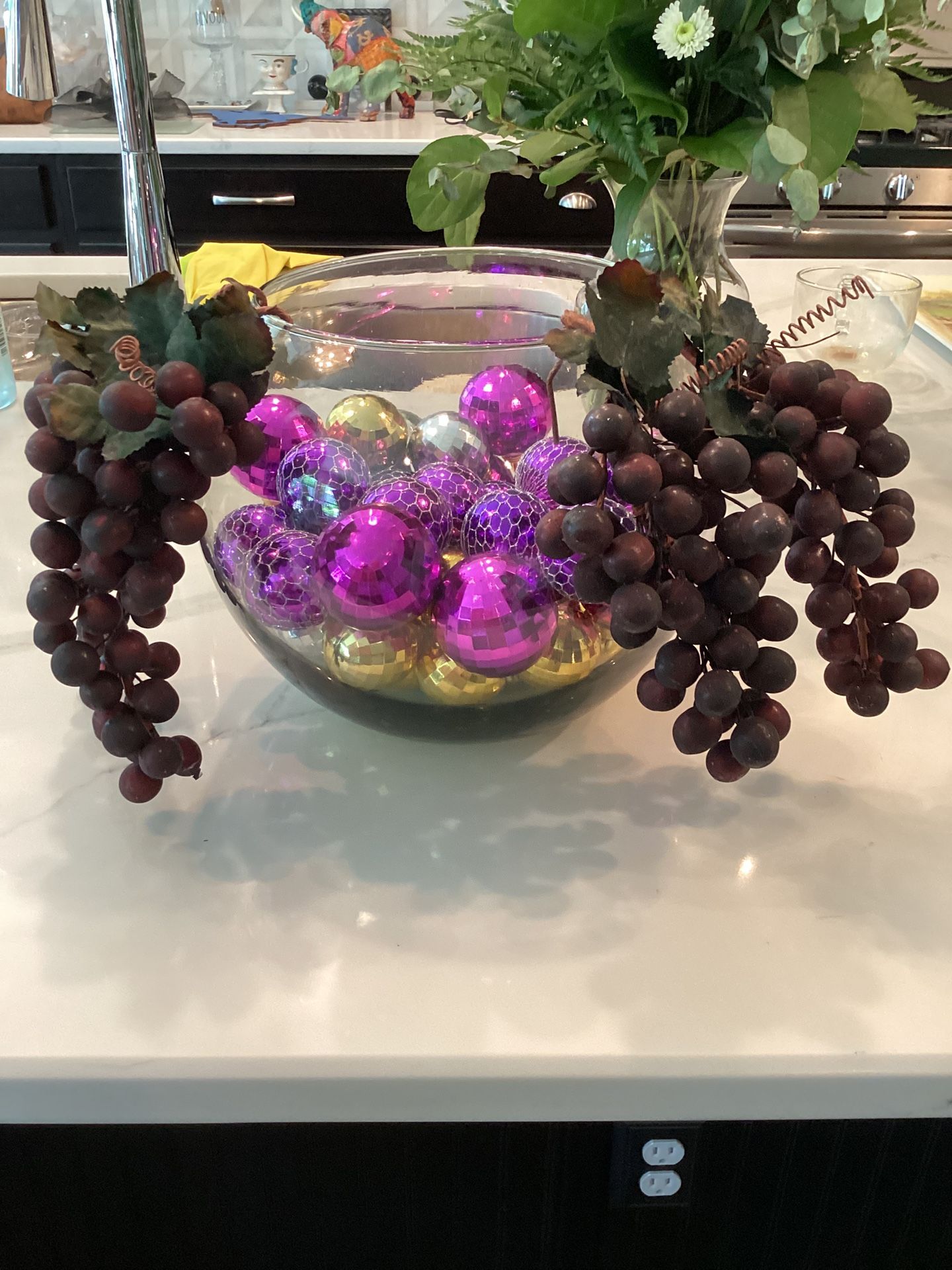 Glass bowl filled with 36 purple and gold ornaments, adorned with artificial grapes 8”T