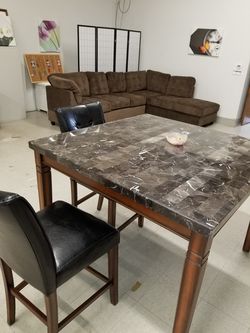 marble counter top table with 4 chairs.
